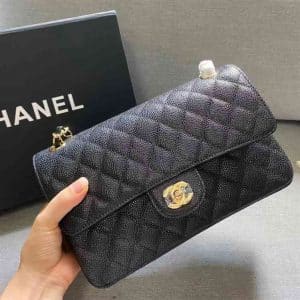 This is CHANEL Caviar Quilted Small Double Flap in Black. This shoulder bag is crafted of luxurious diamond-quilted caviar leather in black.