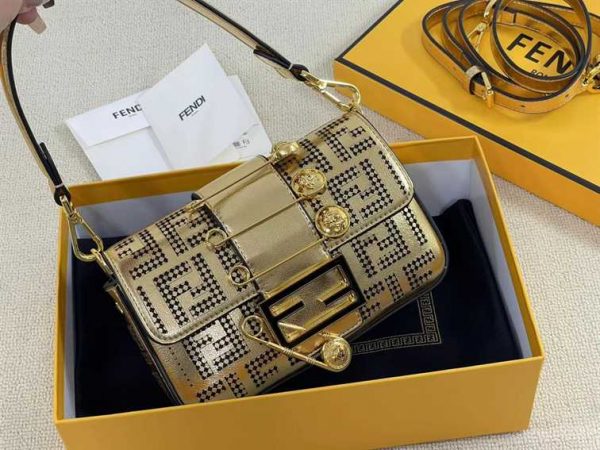 Iconic, boxy mini Baguette bag from the Versace by Fendi collection. Made of gold-coloured leather with FF motif gold laser-cut perforations that create an effect that evokes the Versace metal mesh.